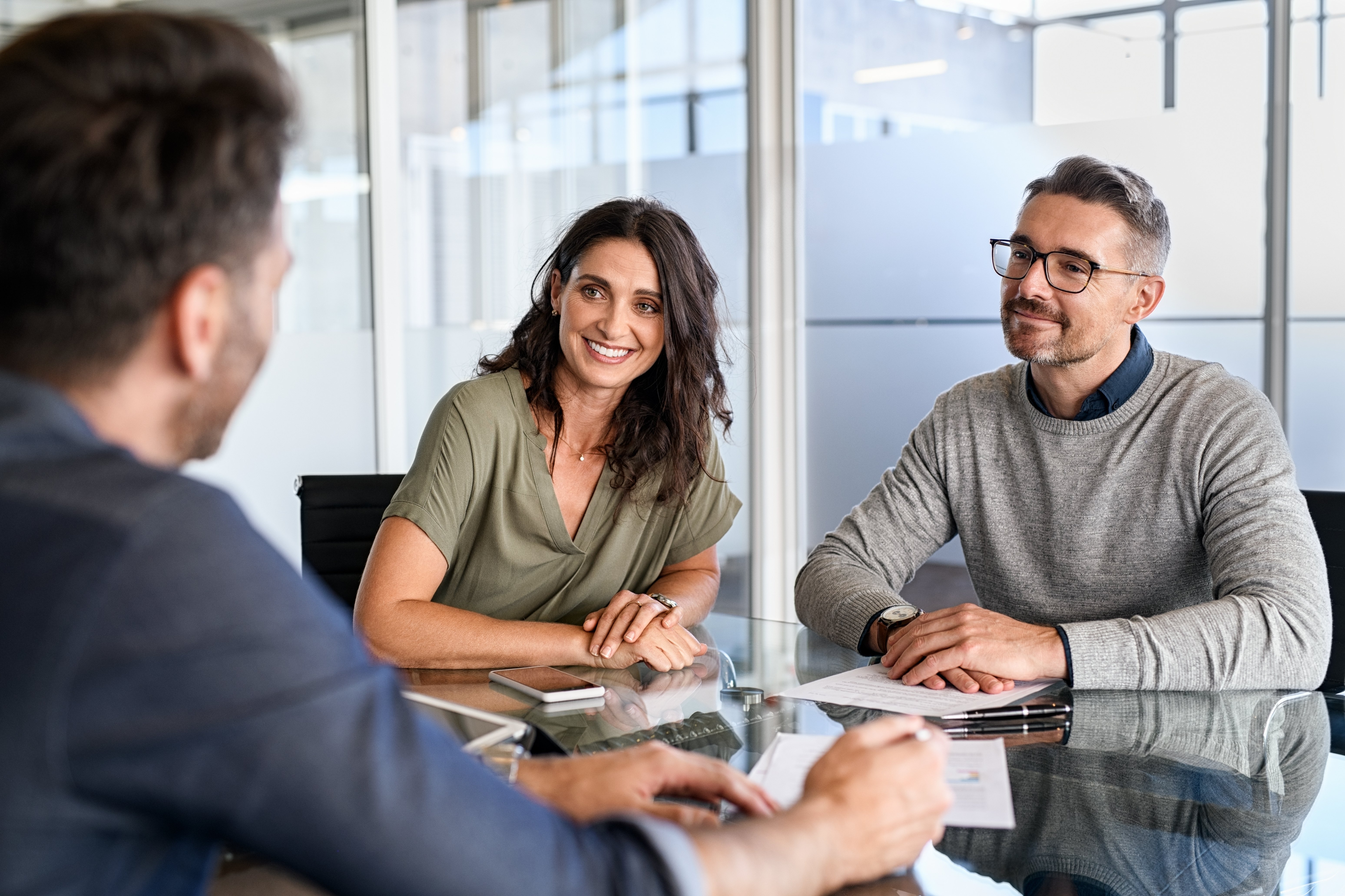 Couple discussing paperwork for loan qualification