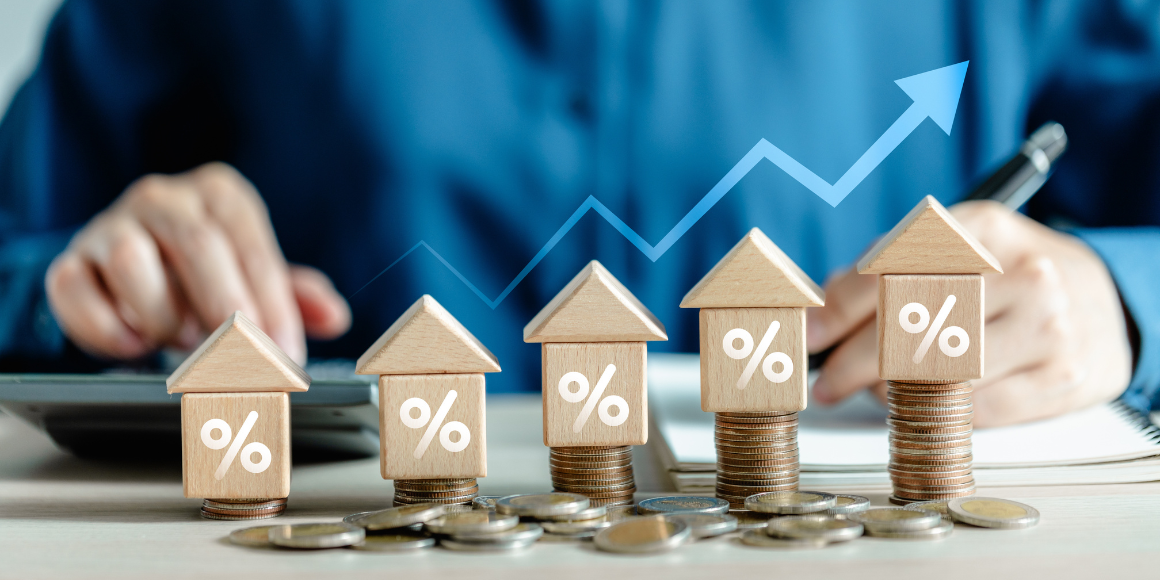 Increasingly tall stacks of coins with small wooden houses on top of each