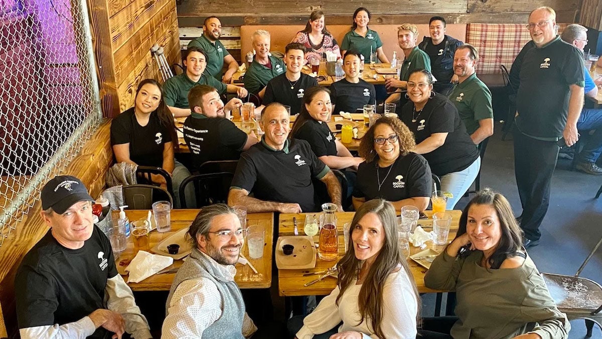 Employees posing for a picture during company lunch