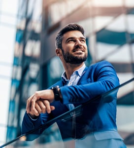 A businessman in blue suit smiling